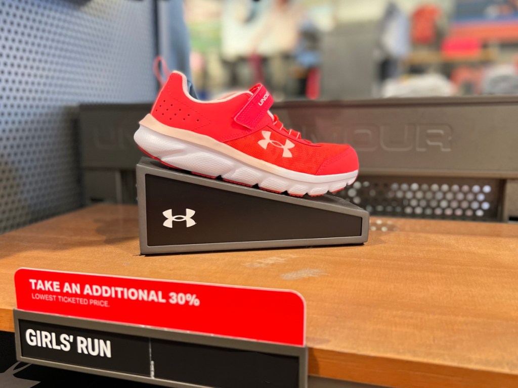 red colored Under Armour Girls Shoe on display in store