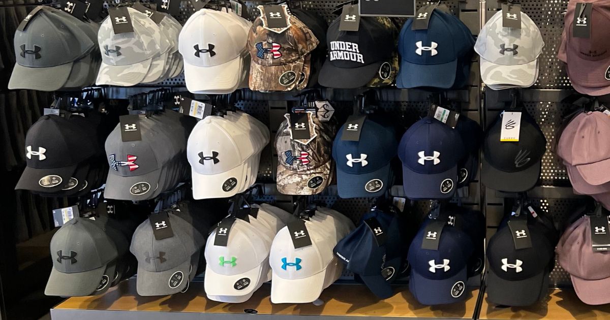 Display of men's Under Armour hats at the store