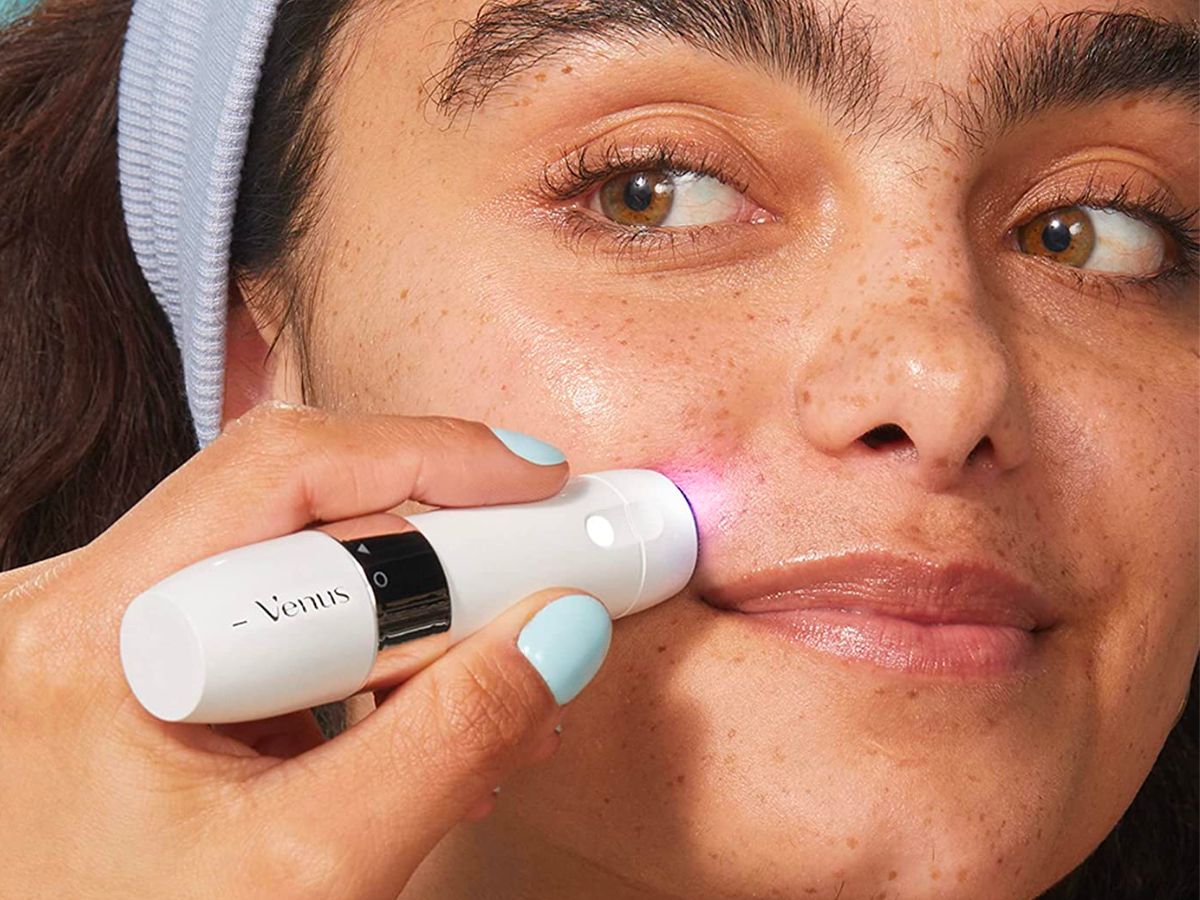 a woman using a Venus gillette mini facial hair remover on her face