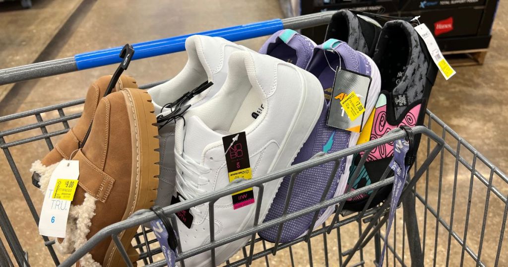 Four pairs of shoes in the top of a Walmart cart