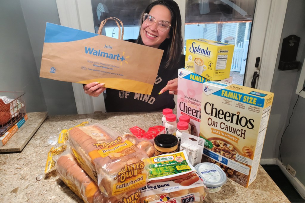 Woman posing with her Walmart Plus Grocery delivery and Walmart Plus shopping bag