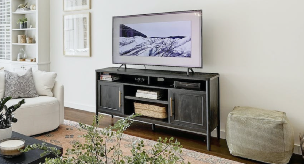Walmart TV stand displayed with tv on it and rug on the floor