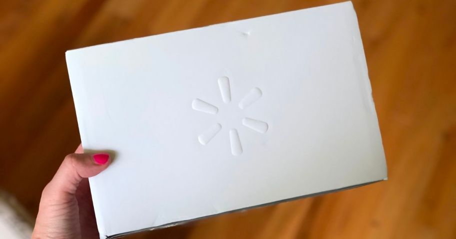 a woman's hand holding a Walmart beauty box