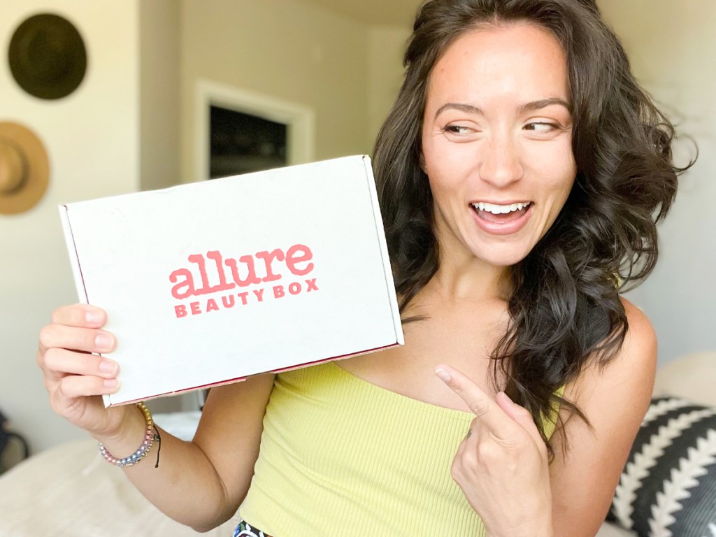 Woman Holding and Pointing at Allure Beauty Box