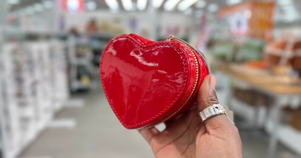 holding a red heart-shaped jewelry organizer