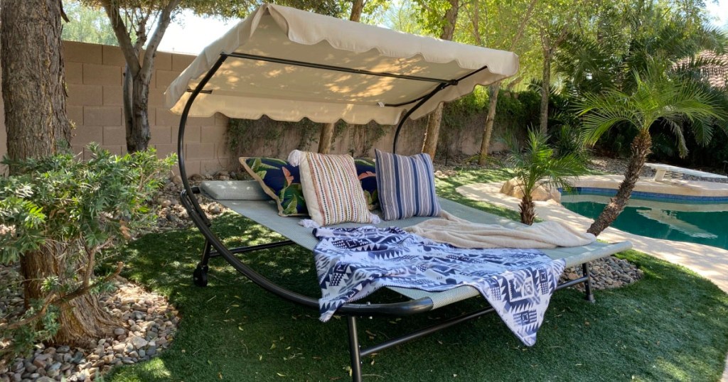 abba hammock with pillows and blankets near pool