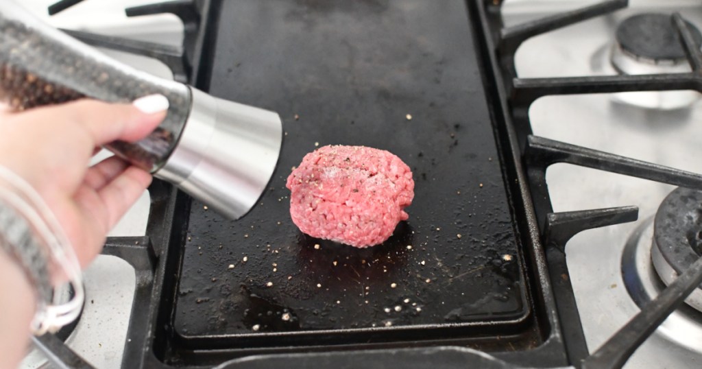 adding salt and pepper to ground beef ball