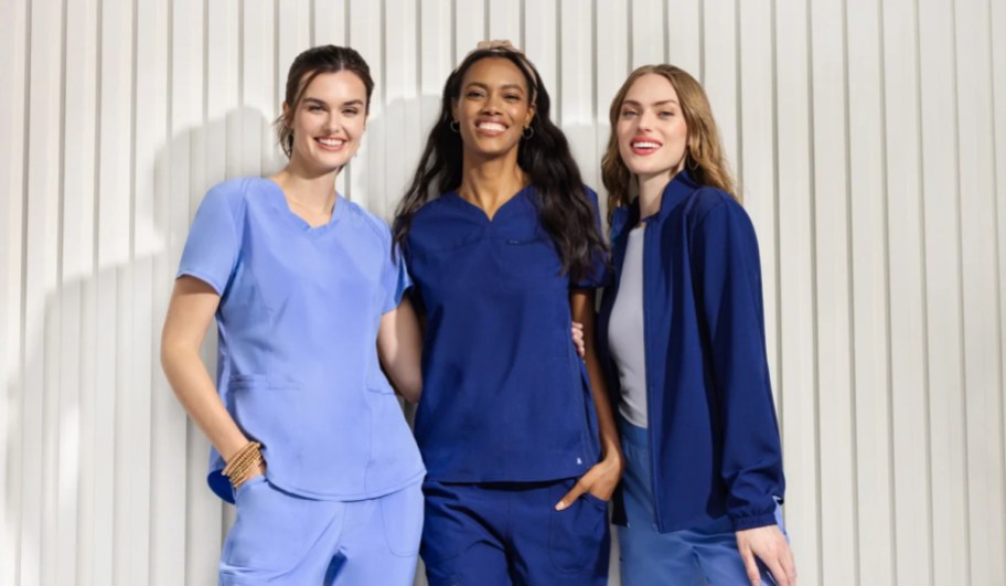 three nurses wearing blue scrubs