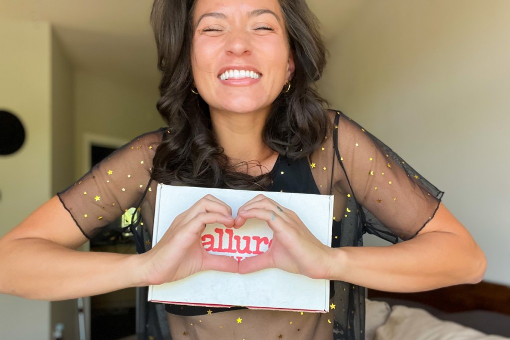 woman holding allure beauty box making heart with hands