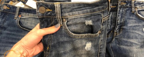 holding a pair of jeans