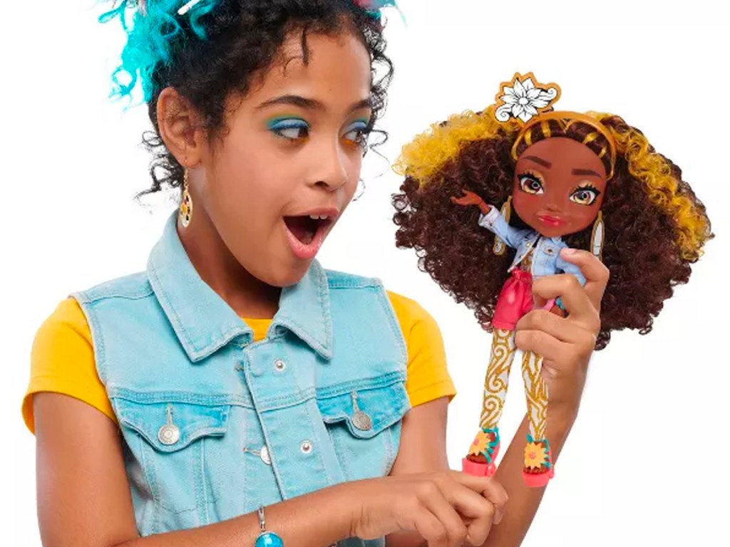 girl holding art squad doll