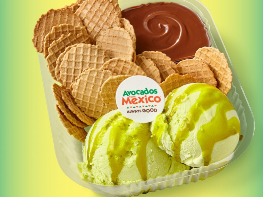 green gelato in a tray with waffle cone chips and chocolate syrup