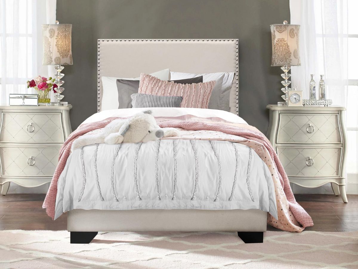 white nailhead upholsered bed frame in bedroom