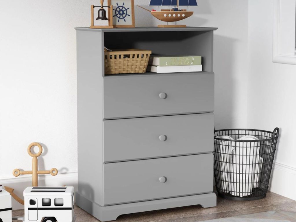 3 drawer and one shelf gray dresser in bedroom