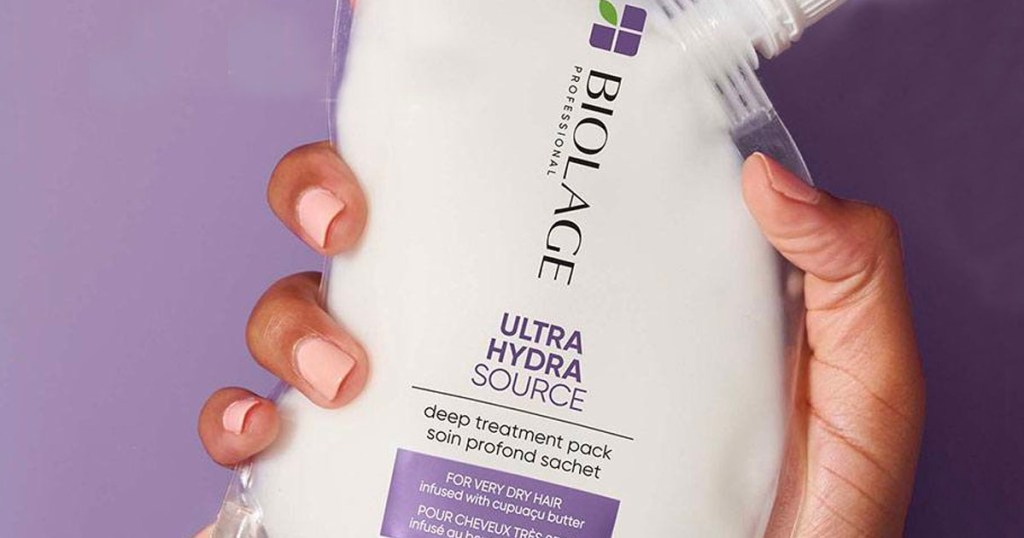 hand holding biolage ultra hydra deep conditioner pack