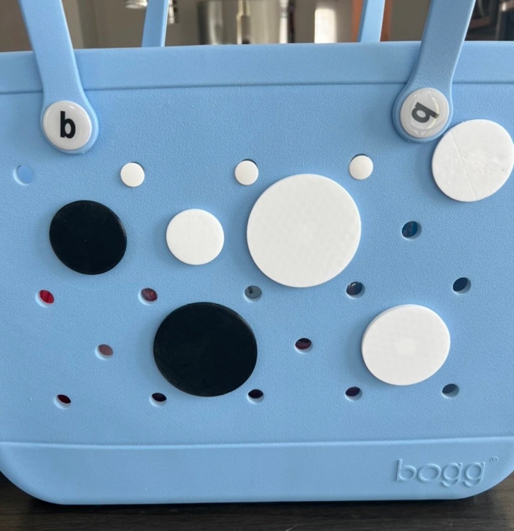 white and black circle decorations on blue bogg bag