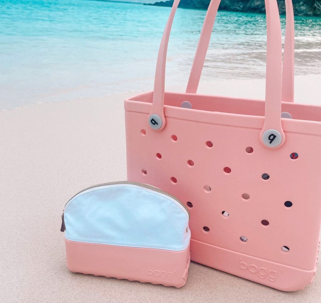pink bogg bag with matching cosmetic bag on sandy beach