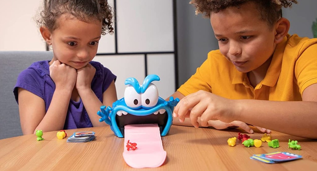 boy and girl playing Gobble Monster Game on the table