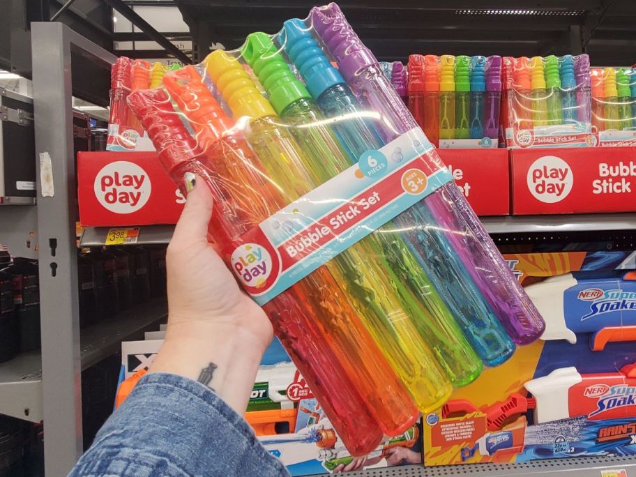 play day bubble stick 6-pack being held by hand in store