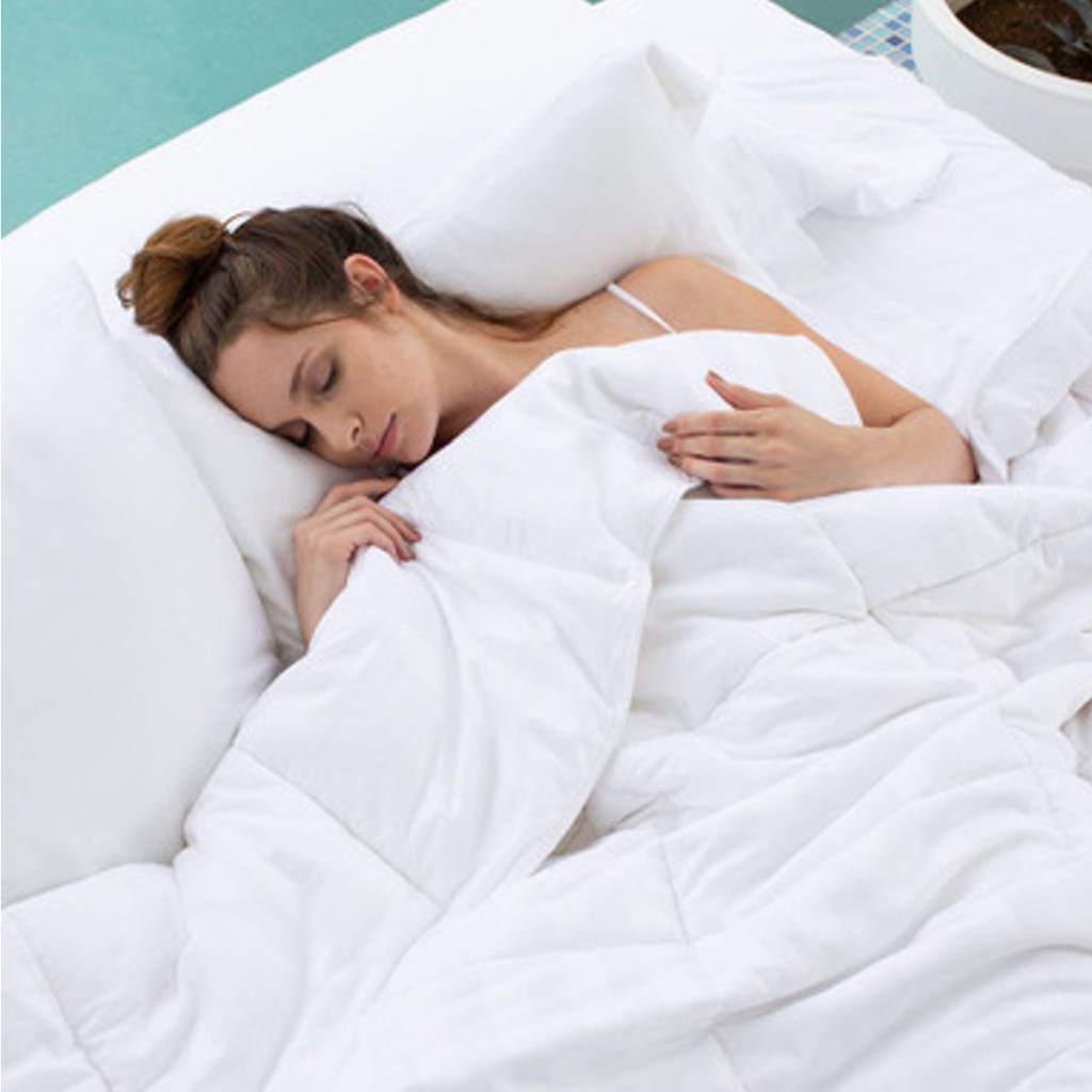 woman sleeping in white comforter