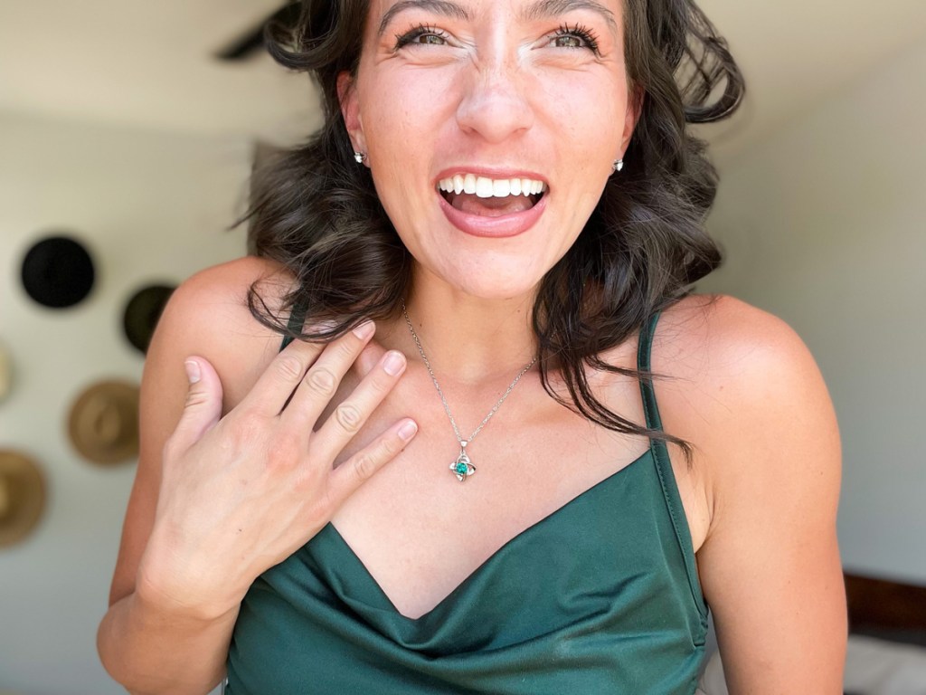 woman in a green dress wearing a cate and chloe birthstone necklace