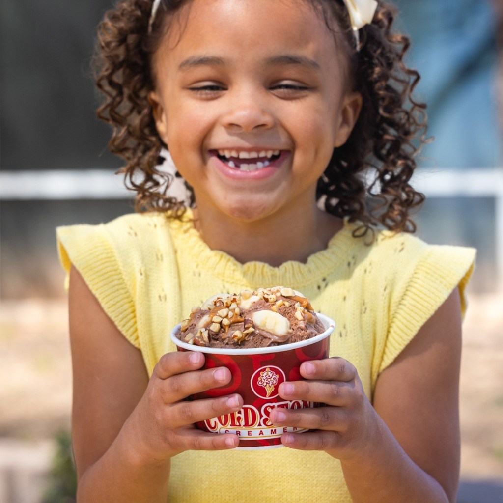girl holding a cup of Coldstone ice cream