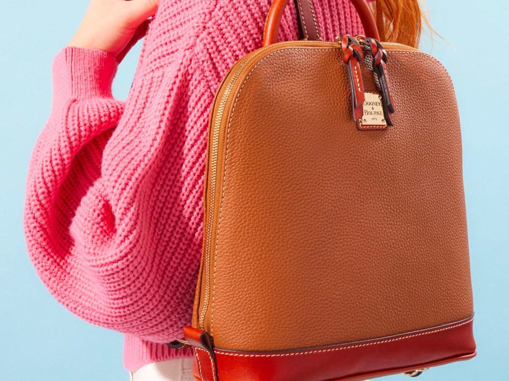 woman wearing brown dooney and bourke backpack