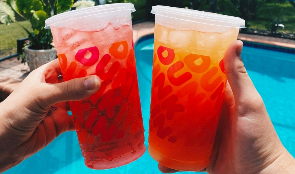 two hands holding dunkin refresher drinks