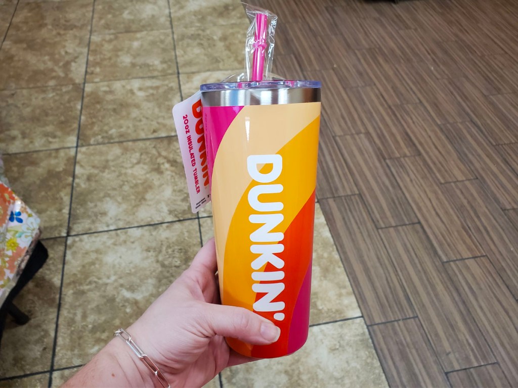 hand holding striped tumbler