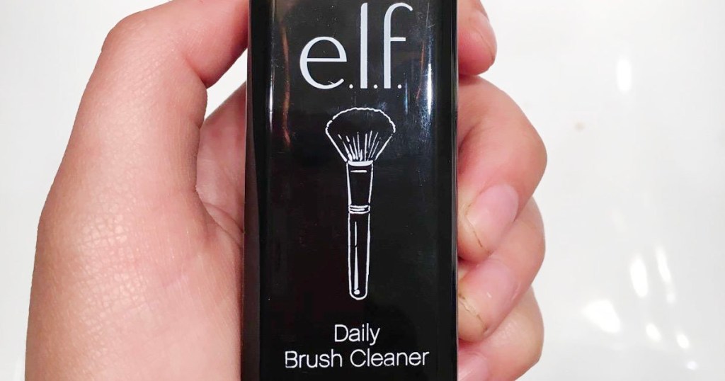 hand holding elf daily brush cleaner