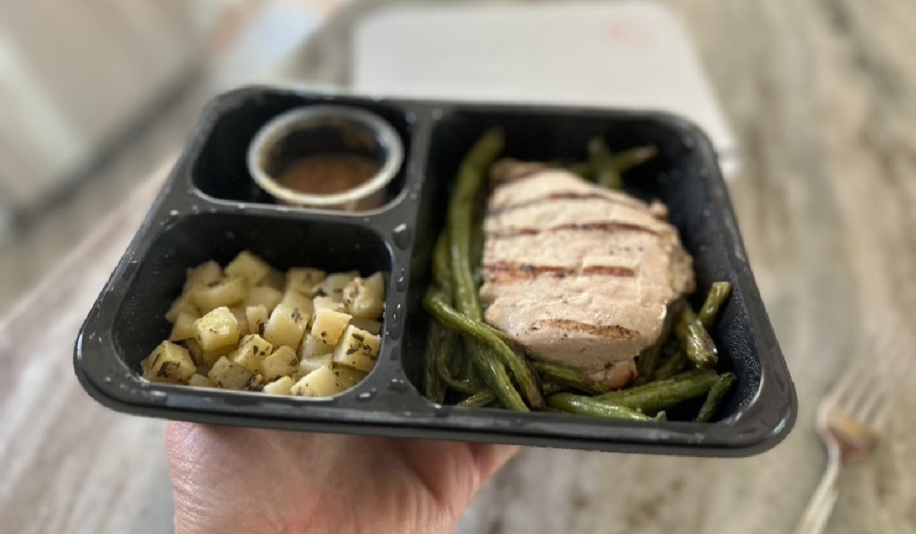 chicken potatoes and sauce in premade frozen meal box