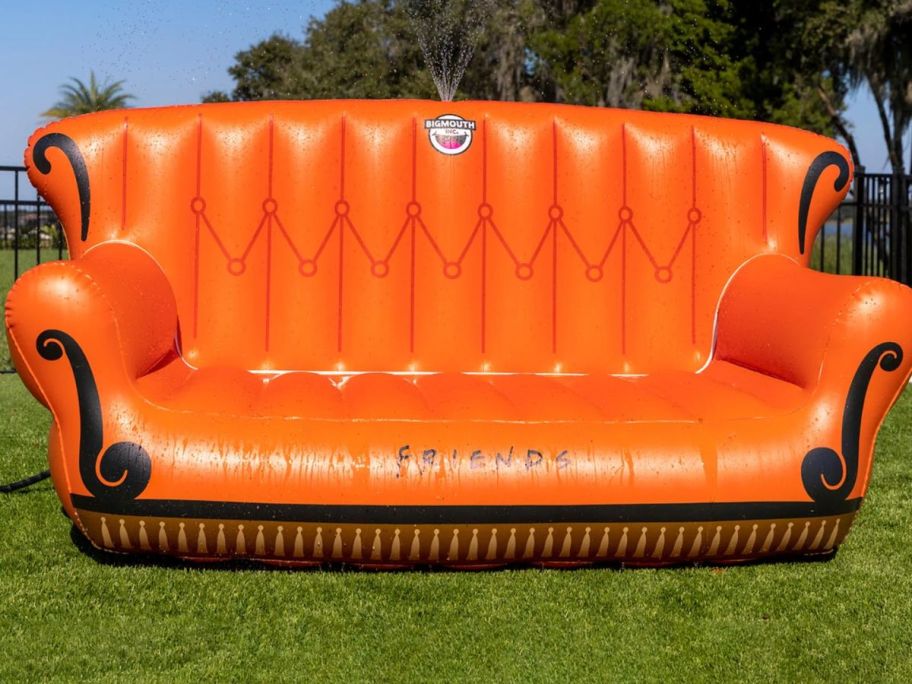 outdoor inflatable friends couch and sprinkler sitting on lawn