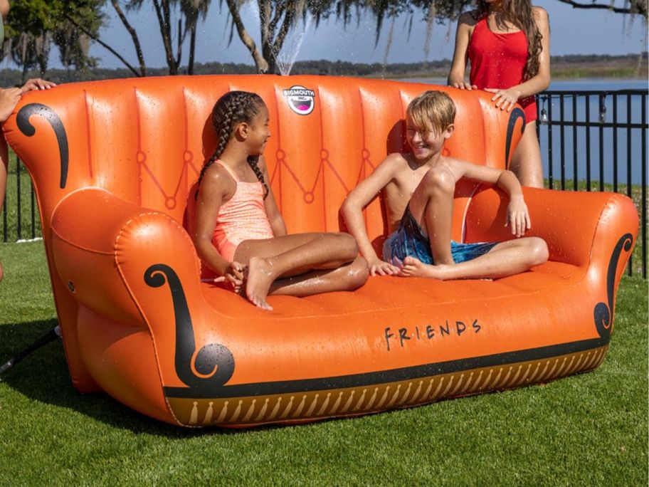 kids sitting on inflatable outdoor couch 