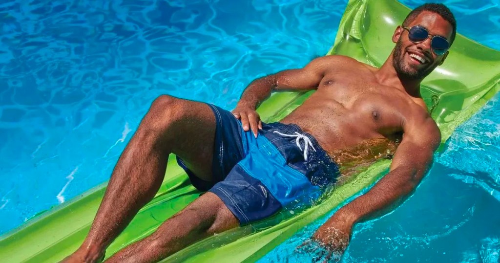 man laying on green pool float