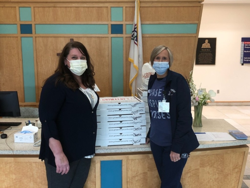 healthcare workers with pizza boxes