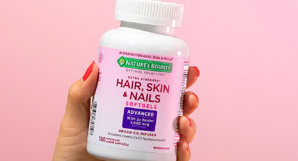 hand holding Nature's Bounty Hair, Skin & Nails Rapid Release Softgels 150 Count