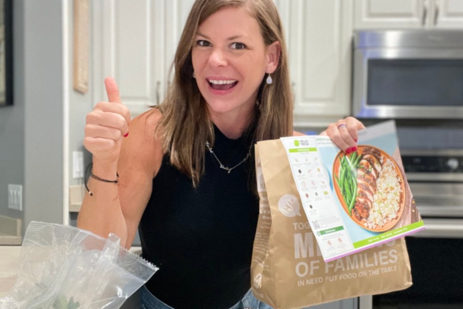 woman with thumbs up holding hello fresh bag