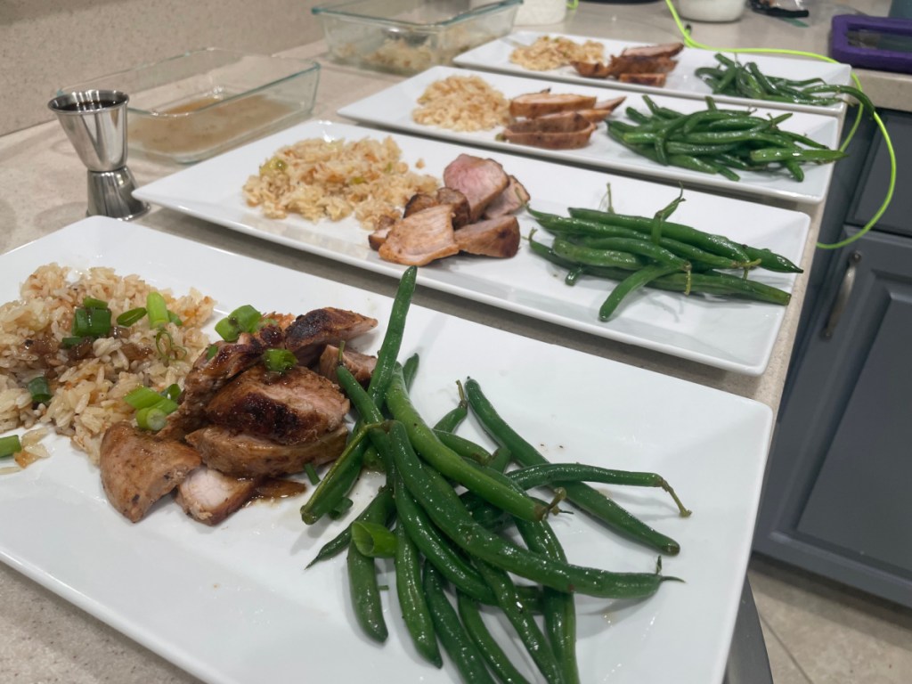 4 plated meals green beans and pork on plate