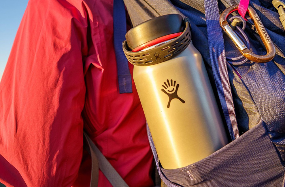 hydroflask in persons backpack that is hiking