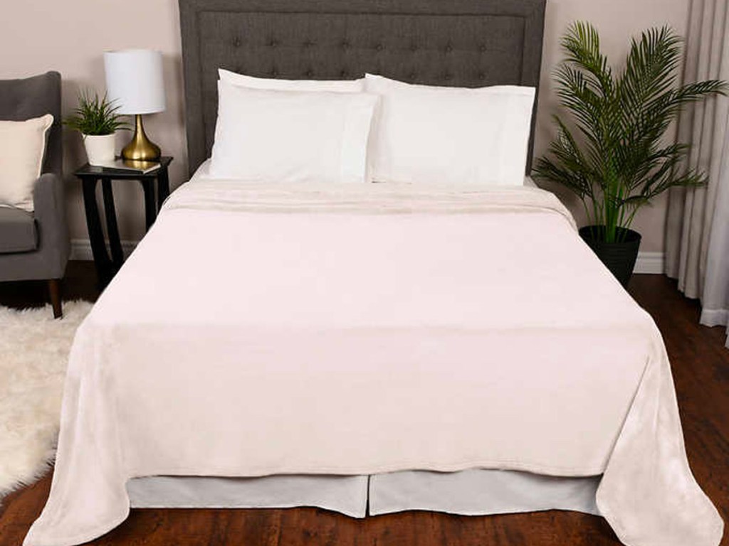 white kirland plush blanket on bed