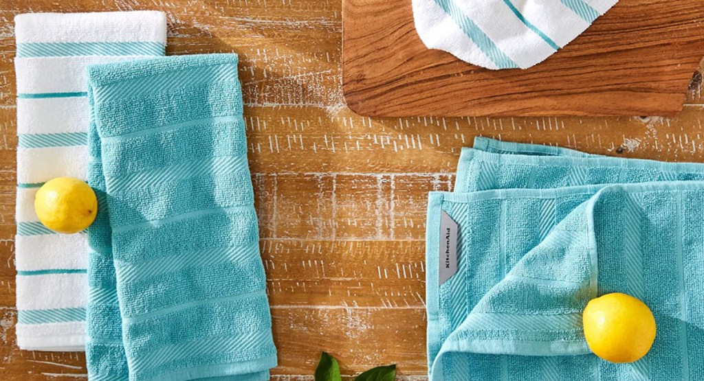 kitchen towels with lemons on them on a cutting board