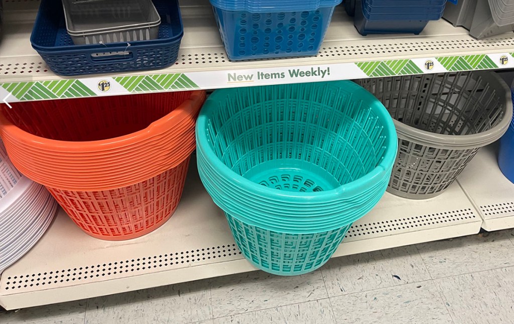 orange, teal and gray plastic laundry baskets on shelf in Dollar Tree