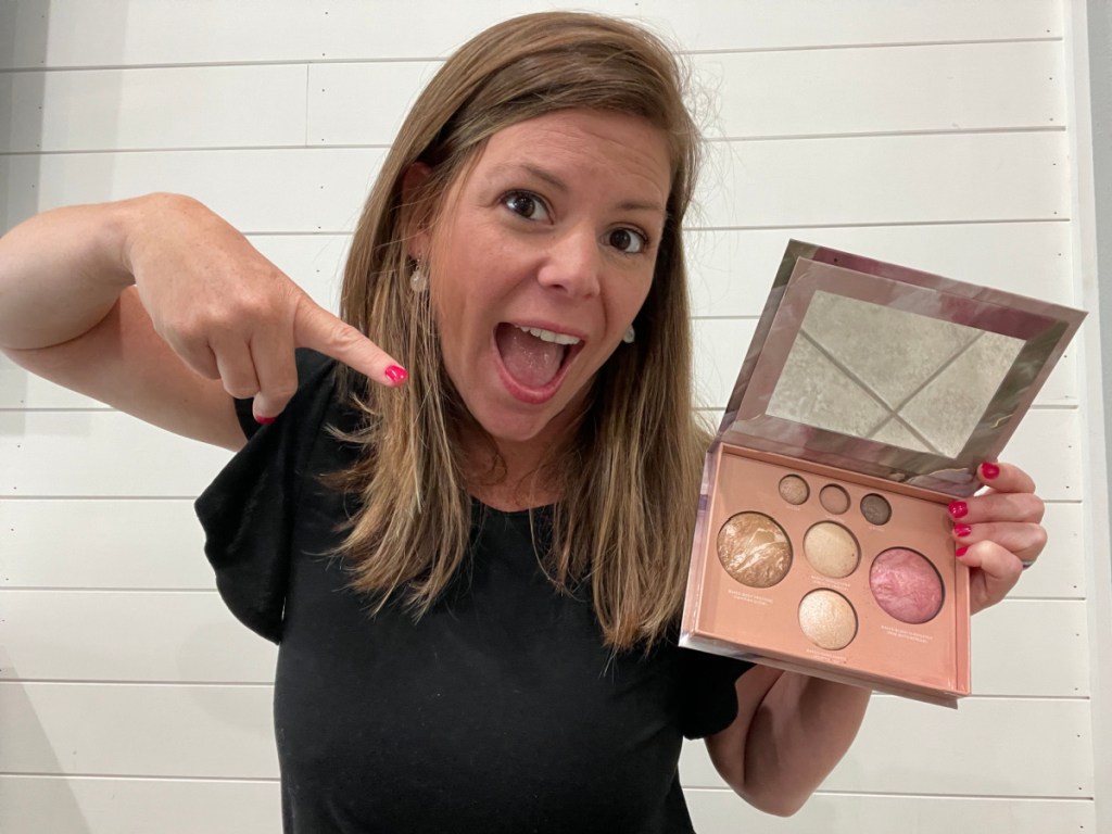 woman pointing at makeup palette