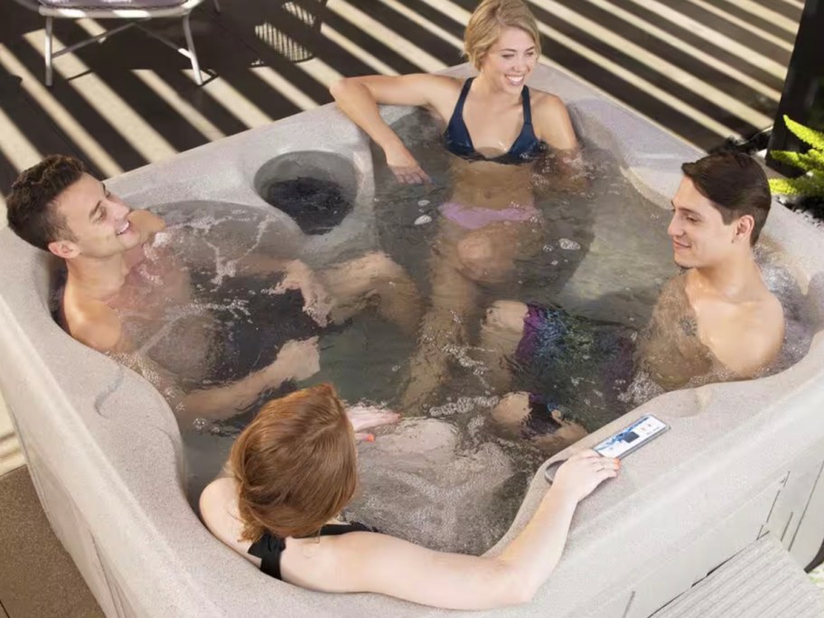 people sitting in hot tub on patio