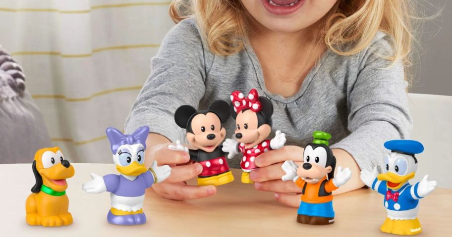 kid playing with Fisher-Price Little People Disney Mickey & Friends Figure Set