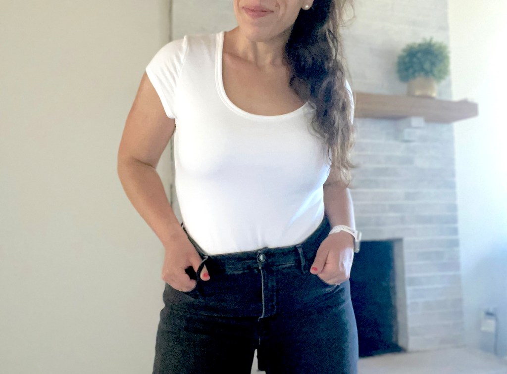 woman posing in white short sleeve bodysuit