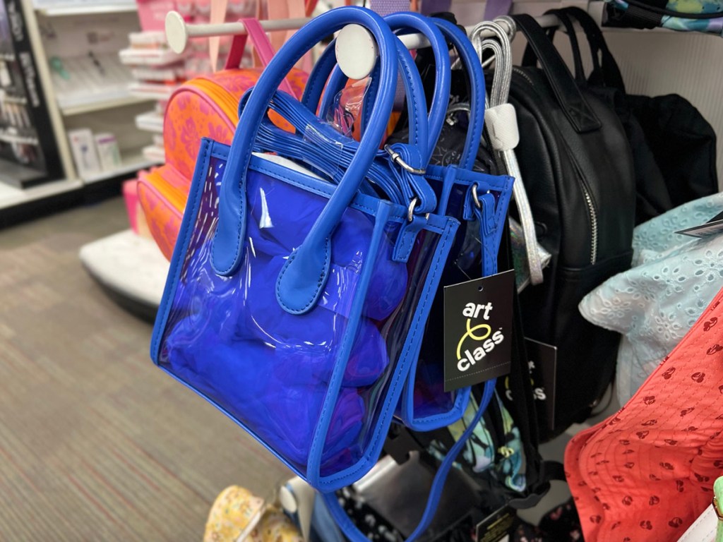 clear blue crossbody bag hanging in store