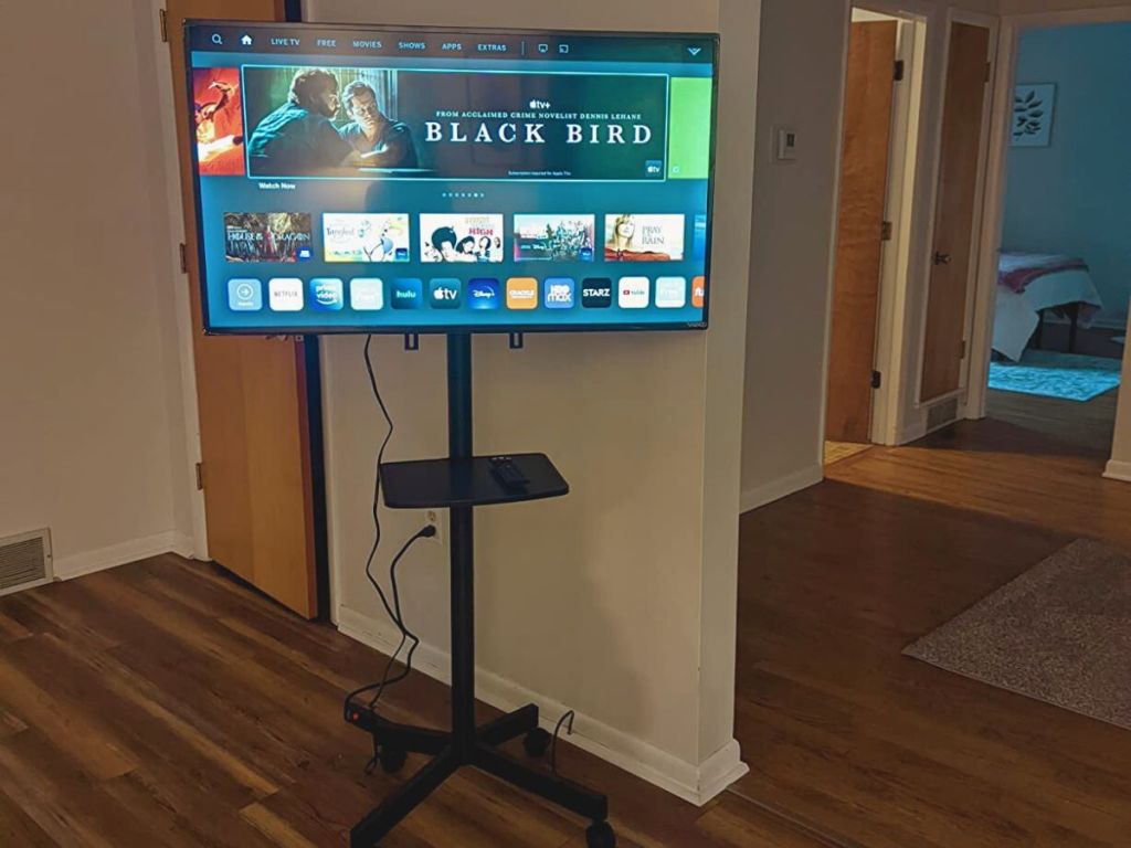 rolling TV stand with TV on stand in living room