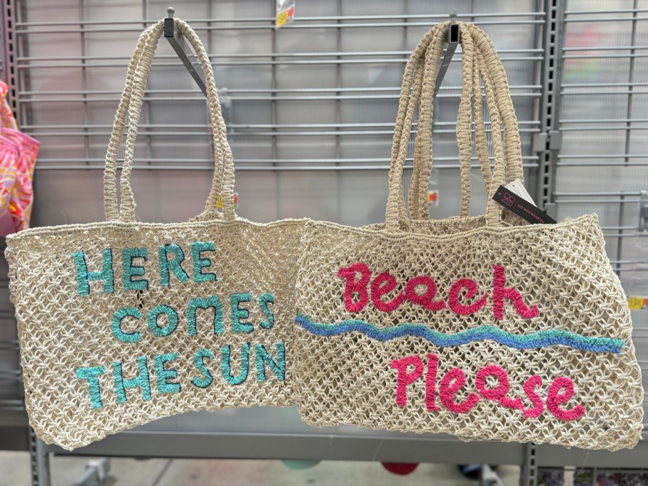 two beach bags hanging on hooks at Walmart