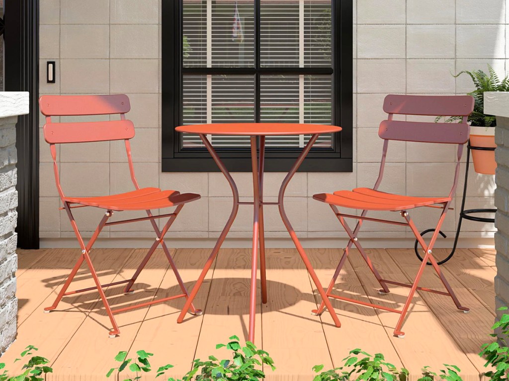 orange metal chairs with matching table on porch